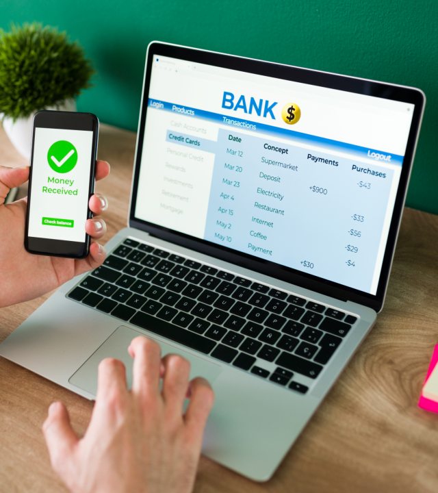 wire transfer young man using his smartphone laptop banking transaction some payments